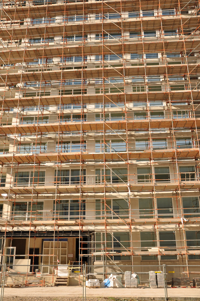 Modern system scaffolding with orange safety components, showing advanced modular design with pre-fabricated connections